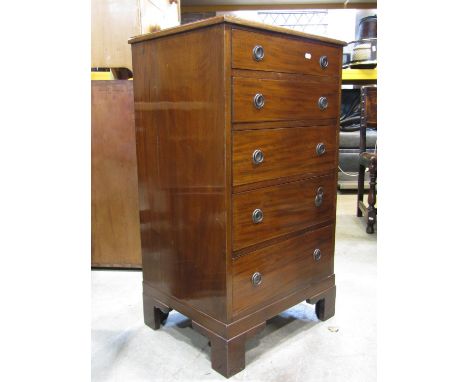 A small mahogany pedestal type chest of five long graduated drawers, with anodised ring handles and raised on bracket support