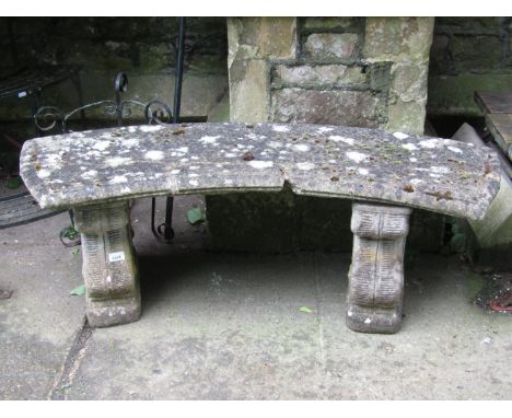 A weathered reclaimed three sectional garden bench with curved slab seat raised on a pair of scrolled supports (AF), 126 cm l