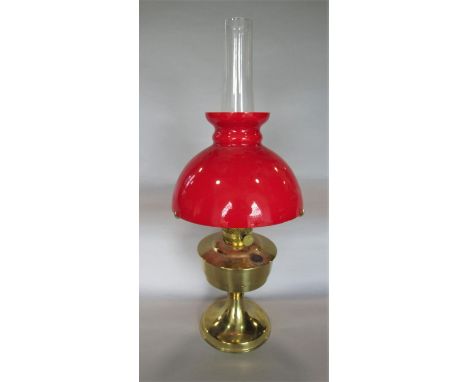 Aladdin brass oil lamp with red shade and flue, 60cm high total 