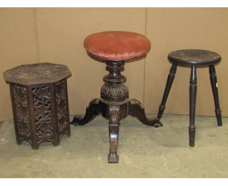 A late Victorian/Edwardian music stool with circular upholstered and revolving seat, raised on shaped tripod supports with ca