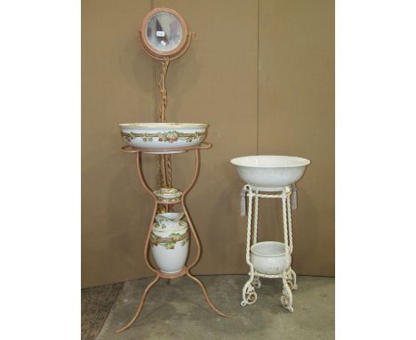 An iron framed floor standing wash stand with raised circular mirror back, over a circular bowl receptacle containing an Adde
