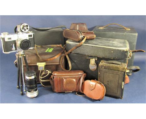 A large collection of mixed vintage cameras and accessories to include lenses, a projector, binoculars, etc 