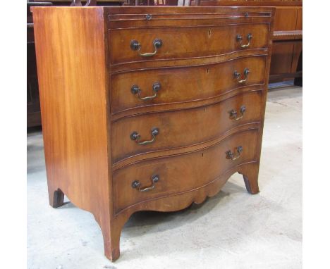 A reproduction Georgian style mahogany bachelors chest, with string inlaid detail, the serpentine front with brushing slide o
