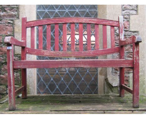 A stained and weathered teak two seat garden bench with slatted seat and oval slatted panelled back 111 cm wide 