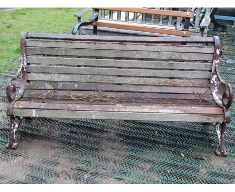 Late 19th century garden bench with decorative iron ends and timber lathes 