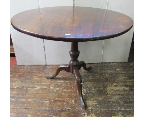 A Georgian mahogany snap top table, the circular top 90cm diameter, raised on a vase shaped pillar and tripod base 