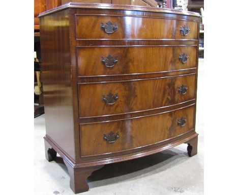 A reproduction Georgian style mahogany bow fronted chest of four long graduated drawers with well matched flame veneers, rais