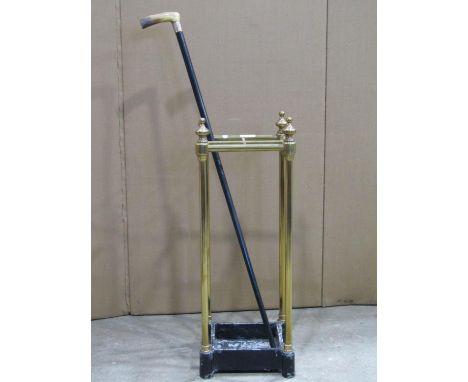 A four divisional tubular brass umbrella/stick stand, with turned finials and cast iron base, approx 22cm square x 60cm high,