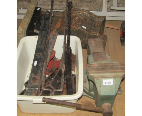 A heavy cast iron bench vice, together with a reclaimed cast iron drain water hopper and further reclaimed strapwork hinges, 