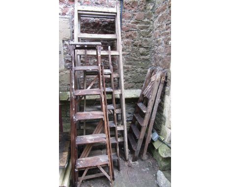 Three pairs of vintage timber step ladders and a further pair of painters stands, folding form (for display purposes only) 