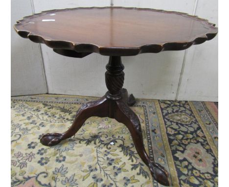 Georgian style mahogany occasional table with pie crust border, raised on a vase shaped column with wrythen fluted detail and