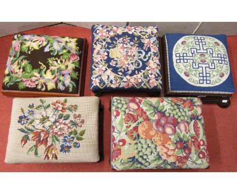 A collection of five footstools of varying age and design, all with hand worked tapestry tops 