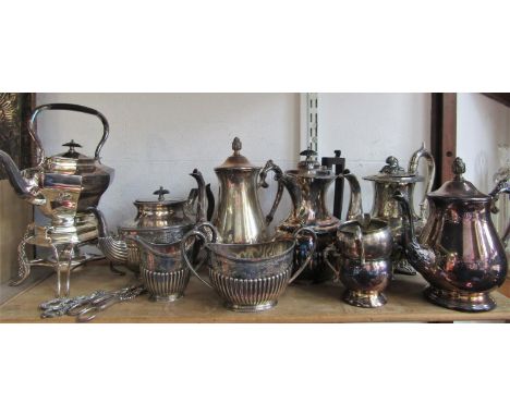 A mixed collection of silver plated teawares comprising a spirit kettle, Georgian style three piece tea service etc; together