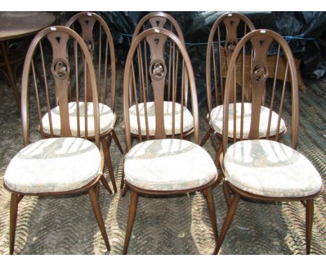 A set of six Ercol stained beechwood Windsor style hoop and stick back dining chairs, with shaped splats and pierced swan det