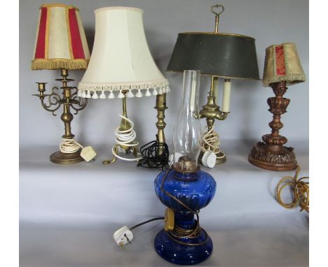 A collection of six good table lamps comprising a three light example with tolware shade and brass stem, a Pullman type lamp,