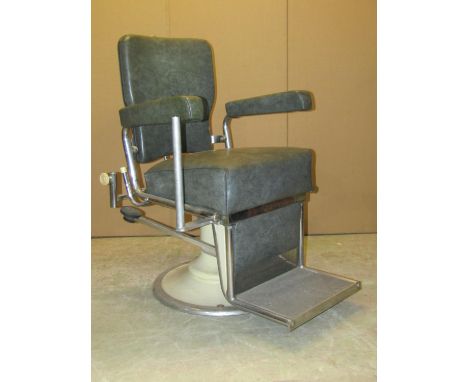 A vintage swivel and adjustable opticians chair with faux leather upholstered seat, back and arms, tubular and cast framework