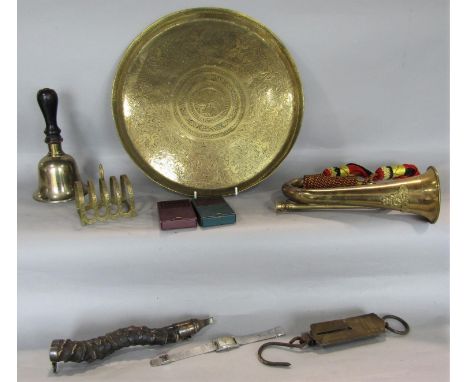 A mixed metal ware lot comprising a military bugle, an eastern brass tray, a hand bell, toast rack, together with a vintage w