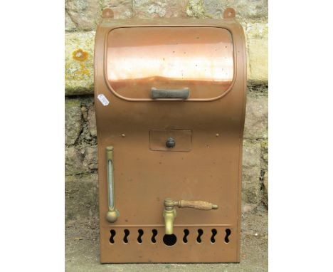 A vintage copper wall mounted water heater with brass tap and fittings 