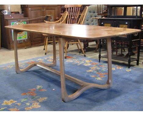 A vintage Windsor light elm and beechwood dining table, the overhanging rectangular top with slightly shaped outline and roun