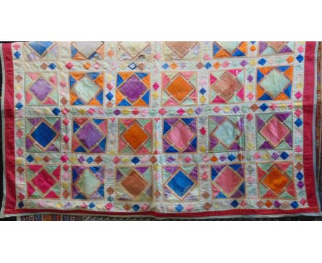 Vintage Indian patchwork quilt, with silk and cotton shapes; paper backed silk squares are edged with piping and further tria