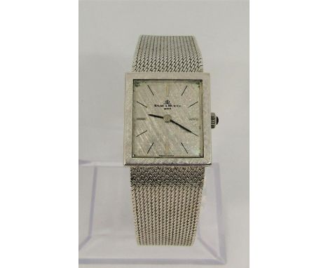 Ladies Baume &amp; Mercier 18ct gold dress watch, the square silvered dial with baton markers with gem set crown and original