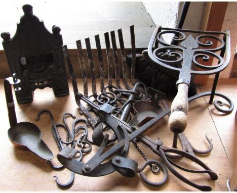 A miniature cast iron fire place, cast in relief with various icons to include Masonic symbols, crossed keys, crucifix, twin 