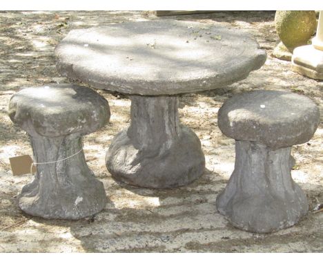 A rustic occasional table in the form of a tree root and trunk together with two small tree stump stools, the table 70 cm dia