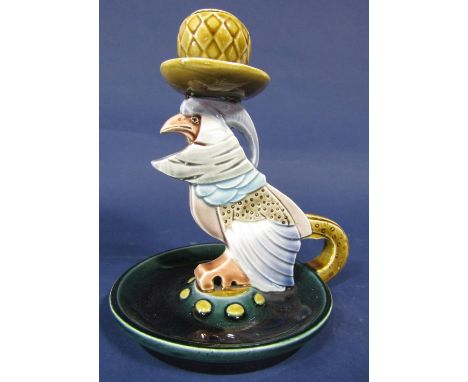 An unusual late 19th century continental chamber stick with majolica type glaze and modelled as a stylised bird of prey and w