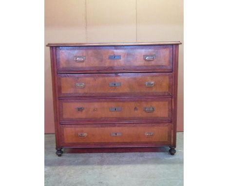 A continental walnut secretaire commode of four long drawers, crossbanded and raised on turned supports, 115cm wide 