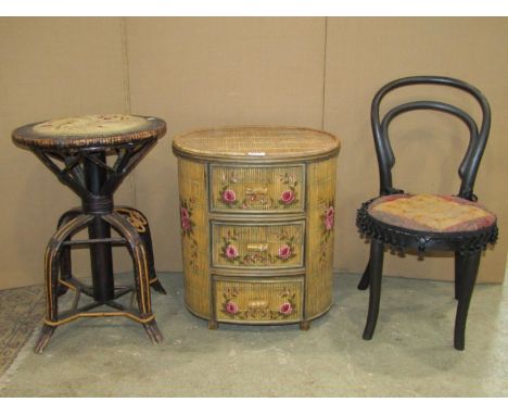 A small split cane and bamboo three drawer chest of oval form with hand painted floral detail, 43cm wide x 33cm deep x 48cm h