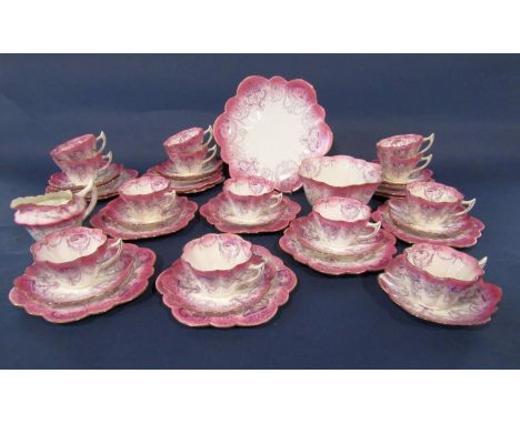 A collection of late 19th century Foley china teawares with fluted rims and pink and purple classical style swag and figure d