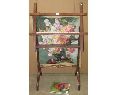 A good and usable 19th century mahogany tapestry framework, with adjustable points bearing an incomplete tapestry and two boo