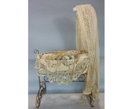 Vintage dolls metal rocking crib with lace drapes  and cushioning, height 90cm 
