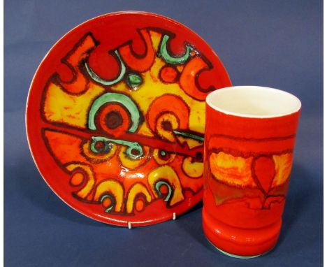 A Poole Pottery charger with red, yellow, orange and green abstract style decoration and with printed mark to reverse and pai