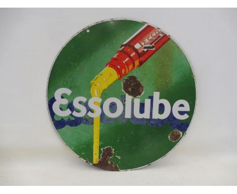An Essolube circular double sided enamel sign depicting oil pouring from a bottle, 26" diameter. 
