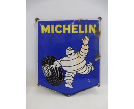 A Michelin pictorial enamel sign depicting Mr. Bibendum rolling a tyre, 26 3/4 x 31 1/2".