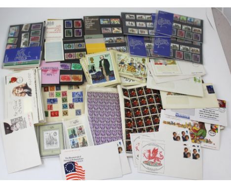 A collection of mid-20th century stamps and first day covers, some in plastic sleeves.