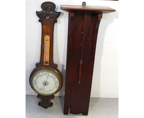 An early 20th century oak-cased aneroid banjo barometer with associated thermometer and mahogany wall-mounted bracket, height