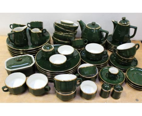 A quantity of 'Apilco' French dinner and teaware, bottle green ground and gilt-heightened, to include plates, cups, saucers, 