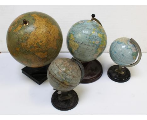 Four vintage world globes, the largest a Phillips 9" terrestrial globe from the London Geographical Institute, 32 Fleet St Lo