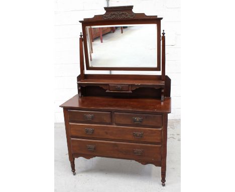 An Edwardian walnut dressing chest, the swing mirror with shelf support surmounts a two-over-two drawer base, on turned legs 