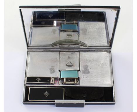 An Art Deco style mid-20th century ladies' compendium, the clock-mounted lid with mirrored interior opens to reveal lipstick,