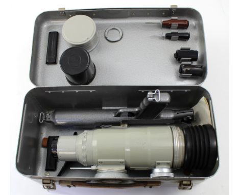 A Russian Photo Sniper photo gun for a Zenit ES Reflex camera, with pistol grip, telephoto lens, tools, film canisters, and f