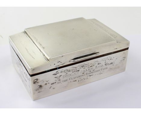 A George V hallmarked silver Art Deco shaped two-division cigarette box with engine-turned decoration to the hinged lid, bear