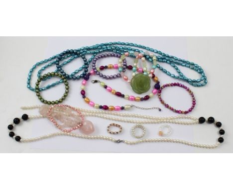 A double-strand white pearl and black bead necklace, a long single-strand turquoise pearl necklace, a three-strand pink pearl