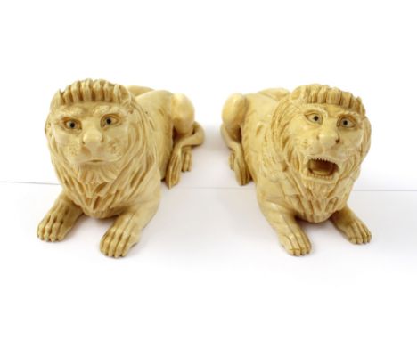 A pair of 19th century carved ivory recumbent lions, length of each approx 13.5cm (2). CONDITION REPORT Hairlines throughout,