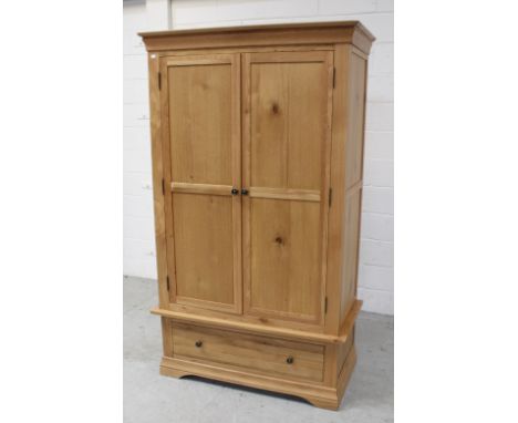 A modern light oak two-door wardrobe on single-drawer base, 192 x 108cm.