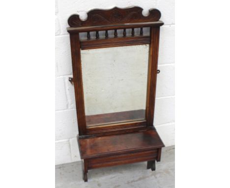 An Edwardian walnut wall-mounted shaving mirror with bobbin-turned gallery to the top and lidded shaving compartment, height 