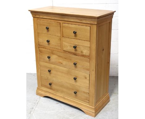 A modern light oak chest of four-over-four drawers, 120 x 98cm.