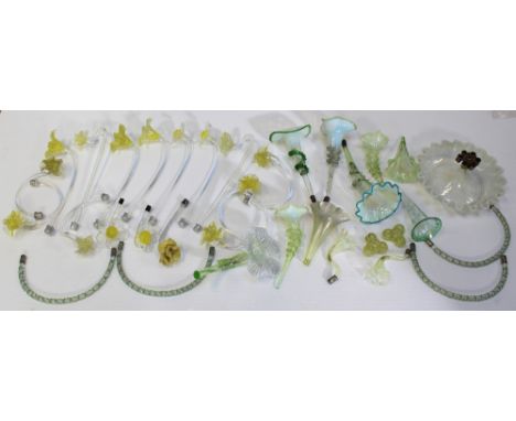 A quantity of epergne branches and trumpets, mainly in yellow and clear glass, some with vaseline edges.